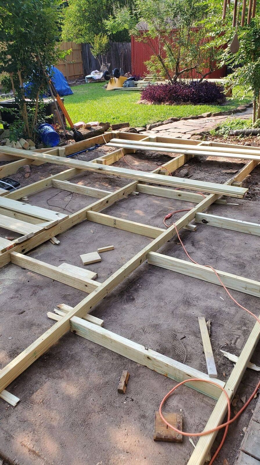 New deck framing laid out in a backyard