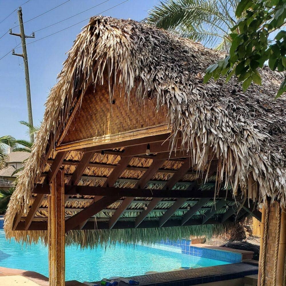 Thatched poolside palapa before conversion to a metal roof