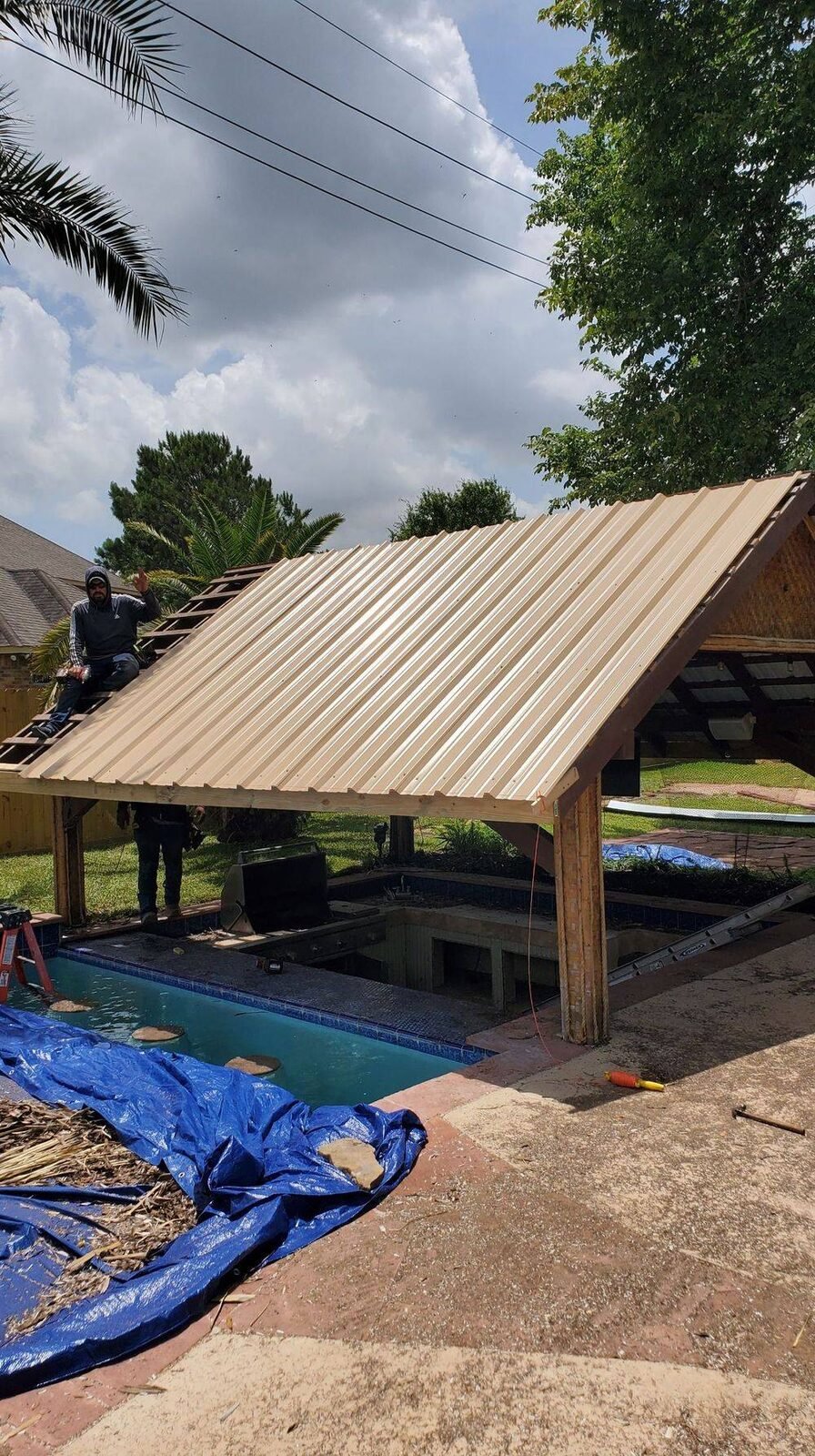 Poolside palapa converted from thatch to a metal roof