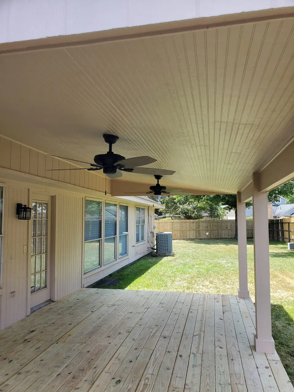 Covered patio with beadboard ceiling and fans