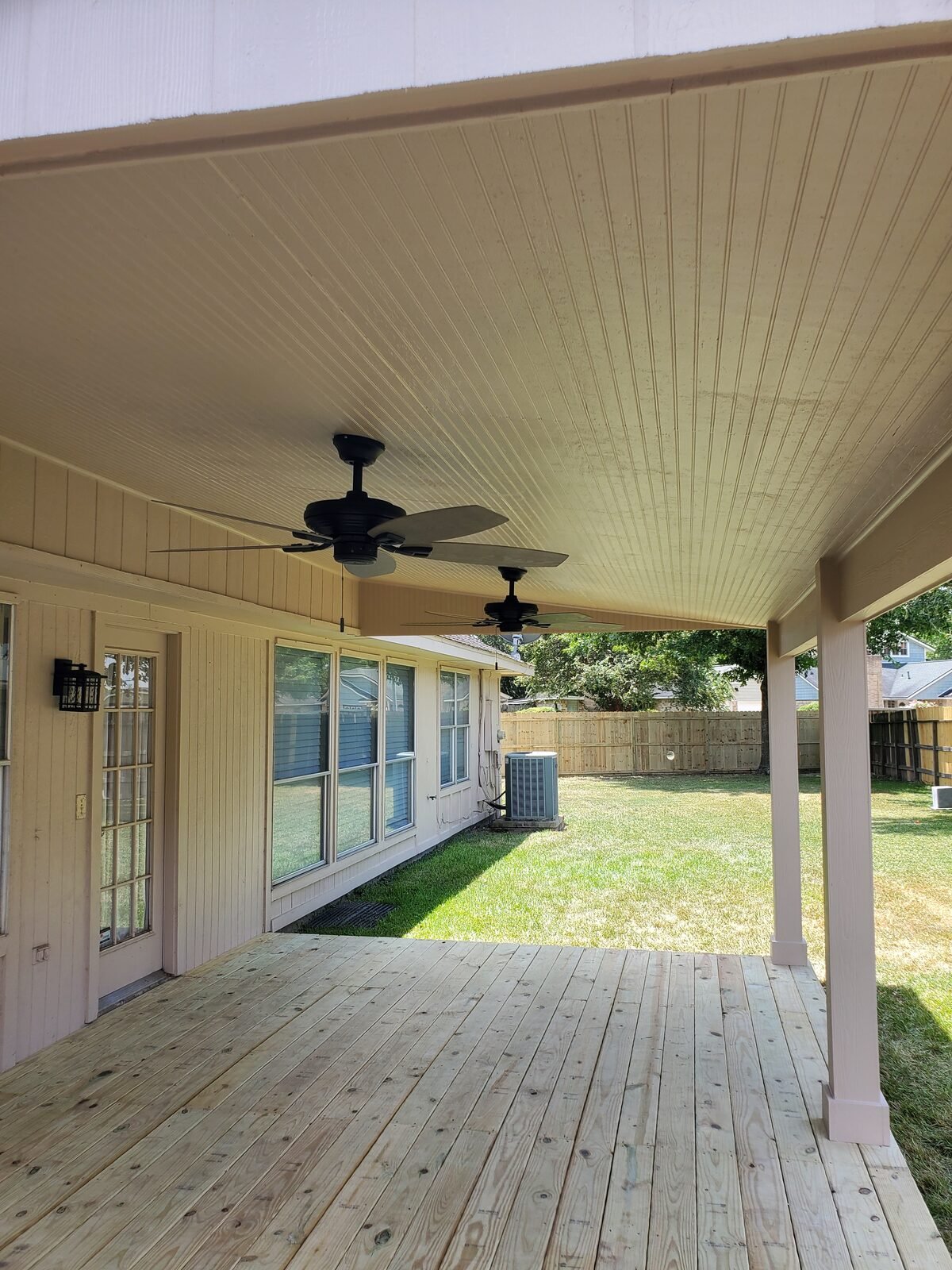 Covered patio with beadboard ceiling and fans