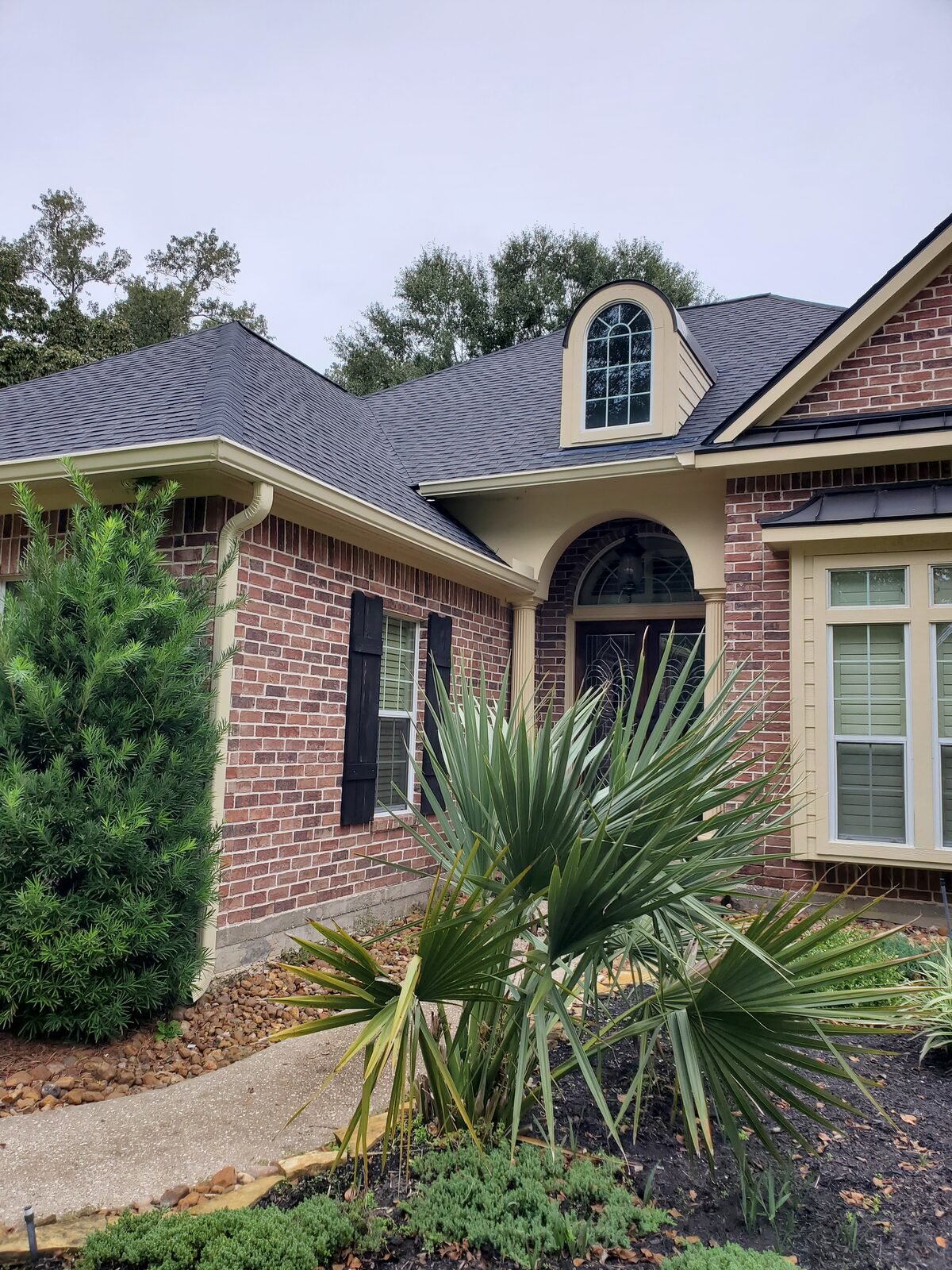 Completed shingle roof replacement on a brick ranch home
