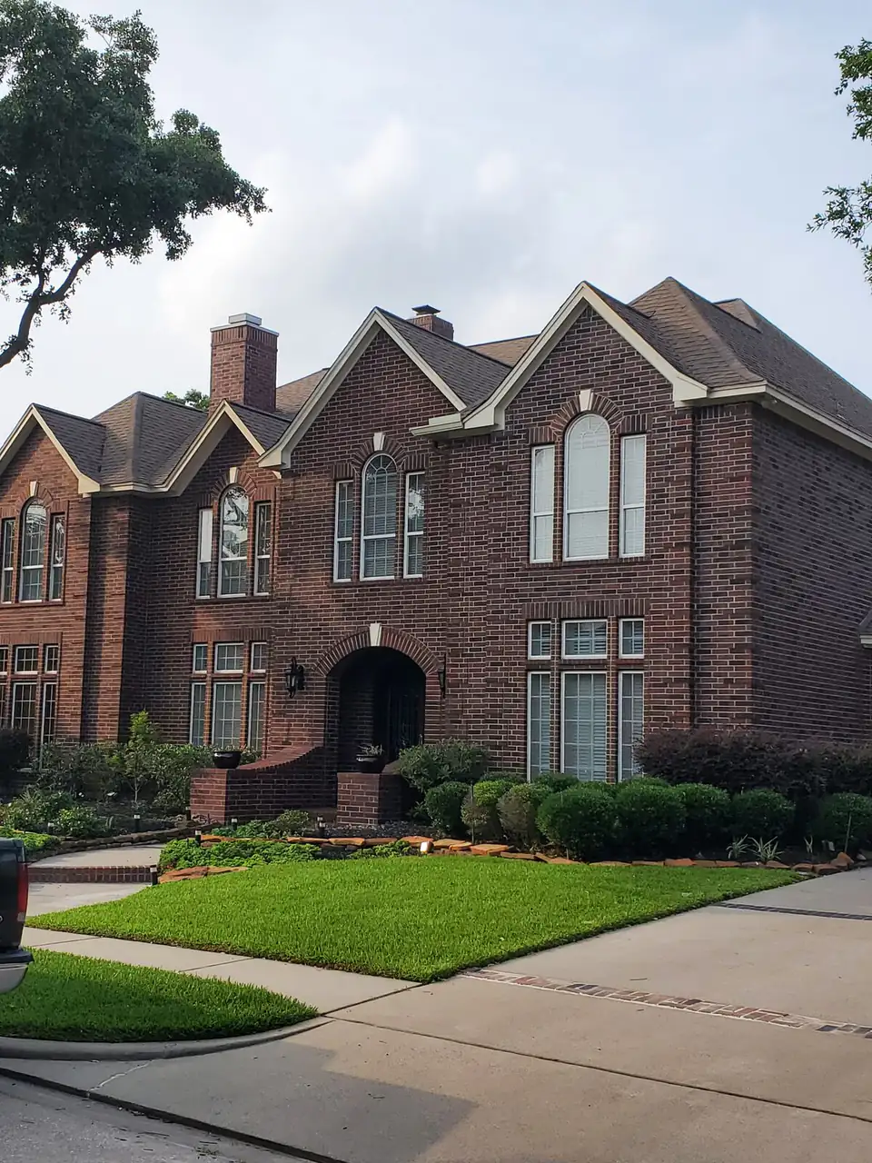 Large two-story brick home with a completed roof replacement