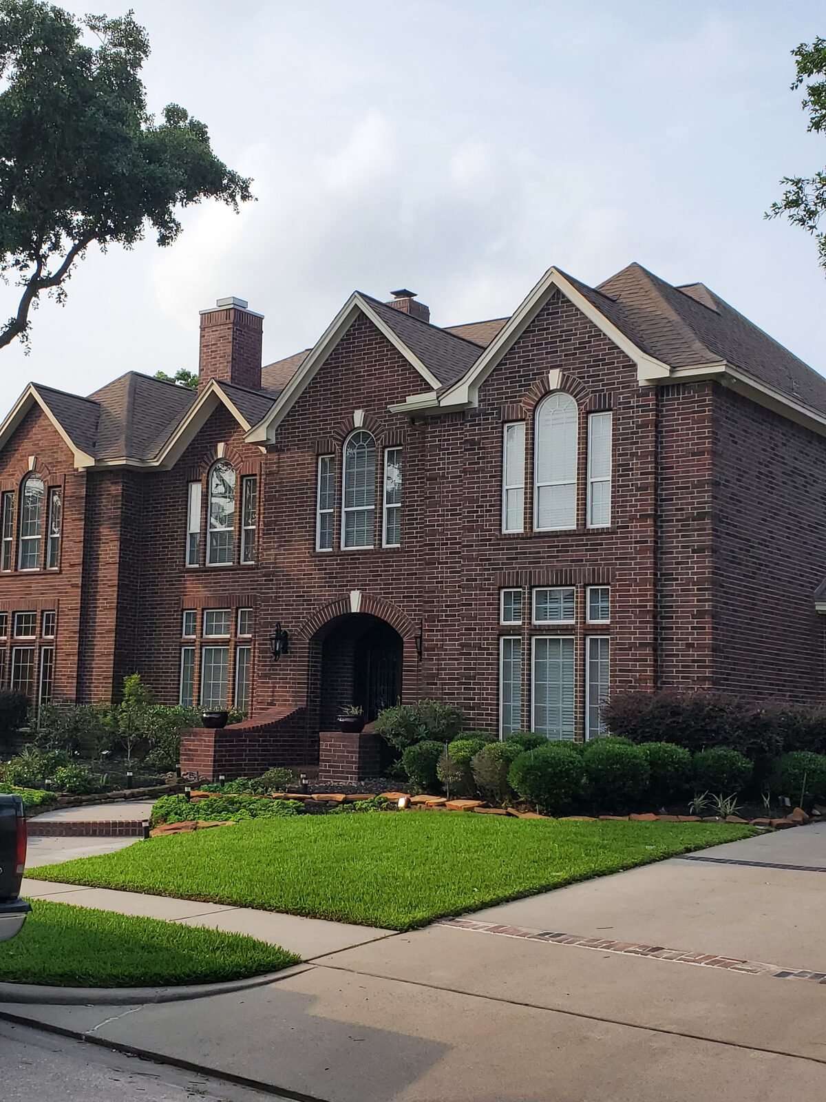 Large two-story brick home with a completed roof replacement