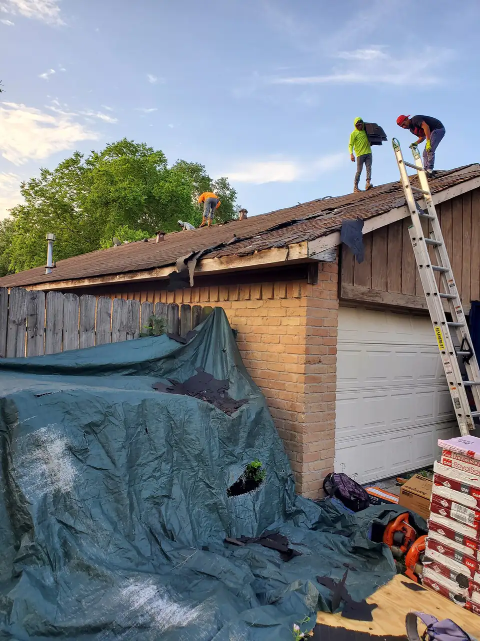Tarped roof with a Triple G crew starting storm damage repairs